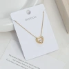 A large heart-shaped pendant with a hollow texture and a small heart embedded inside has a golden texture and a romantic atmosphere full image